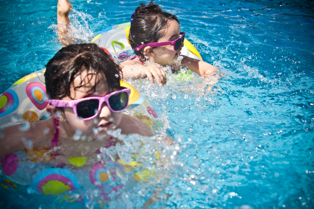 two children playing in a pool